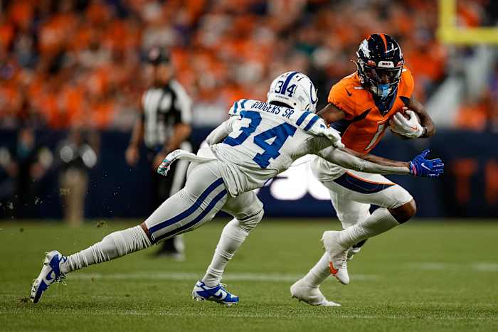 Oct 6, 2022; Denver, Colorado, USA; Denver Broncos wide receiver KJ Hamler (1) runs the ball under pressure from Indianapolis Colts cornerback Isaiah Rodgers Sr. (34) in the second quarter at Empower Field at Mile High.